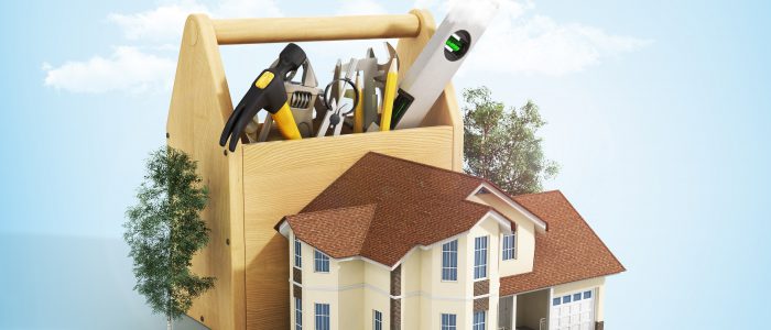 Concept of repair house. Repair and construction of the house. Tool box near a house with trees on the blue background with clouds.