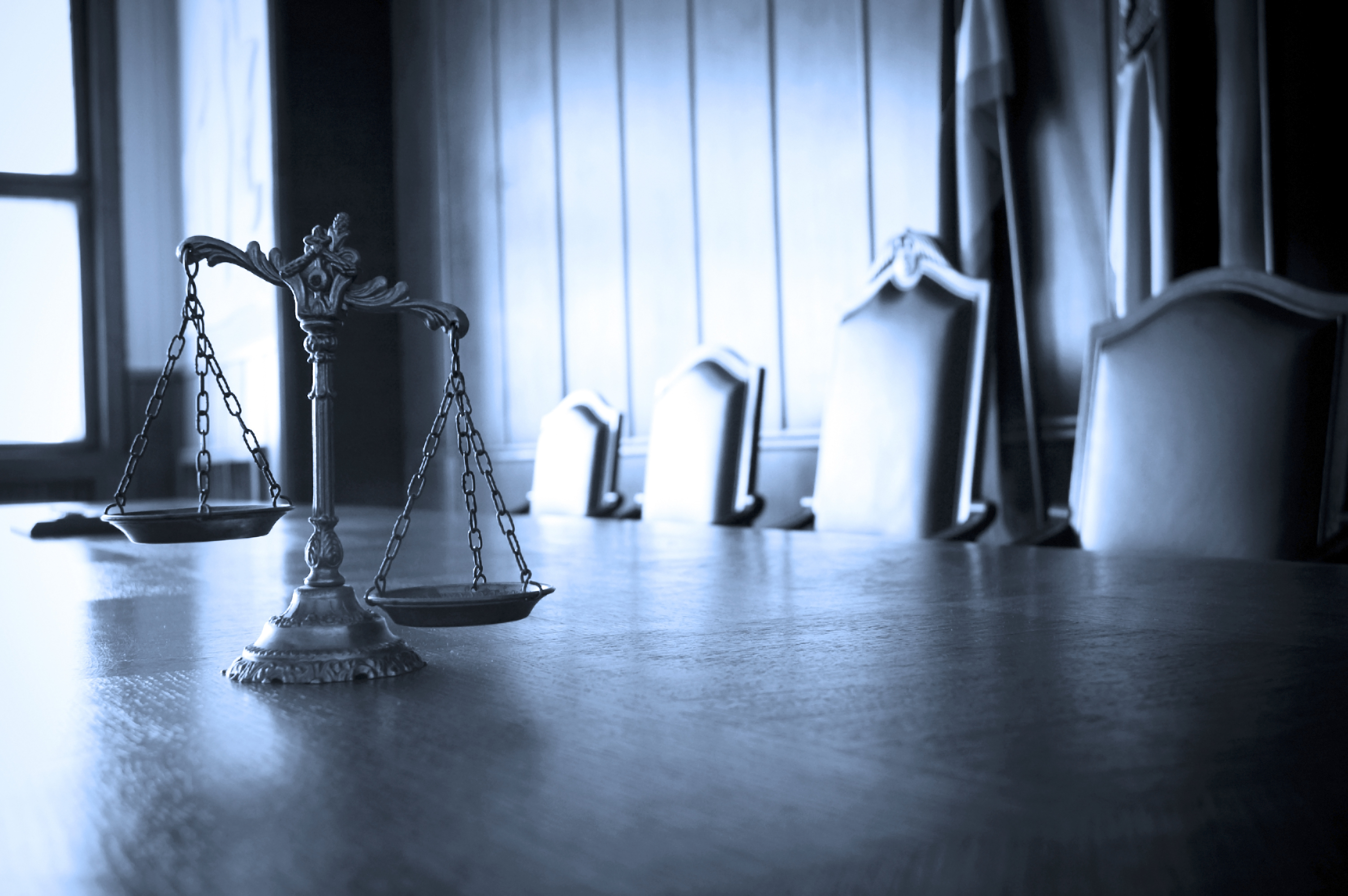 Symbol of law and justice in the empty courtroom law and justice concept BLUE TONE