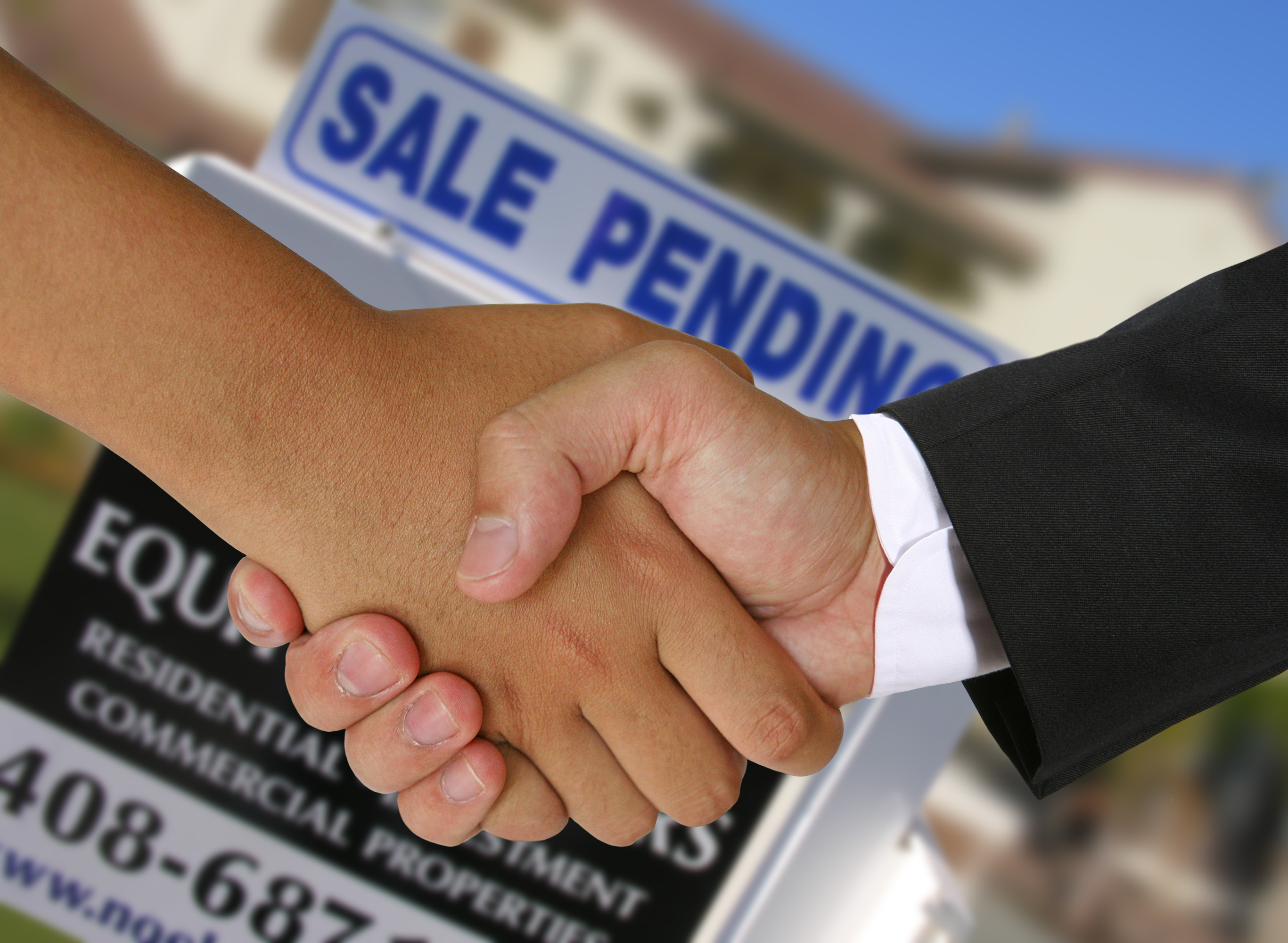 People shaking hands in a real estate transaction
