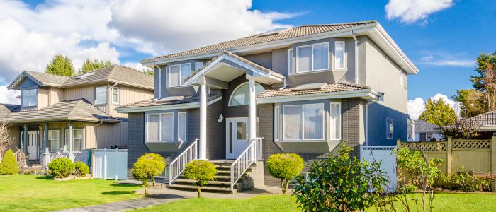 Photo of a home with beautiful green grass on a summer day.