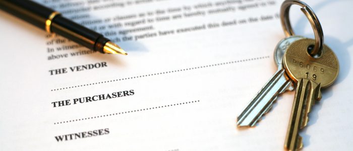 legal document for sale of real estate property in europe, with a gold-nibbed fountain pen and house keys