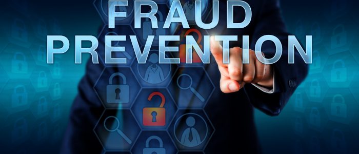 Forensic examiner is pushing FRAUD PREVENTION on a virtual screen. Business services metaphor and law enforcement concept for countermeasures to internet fraud identity theft and computer crime.