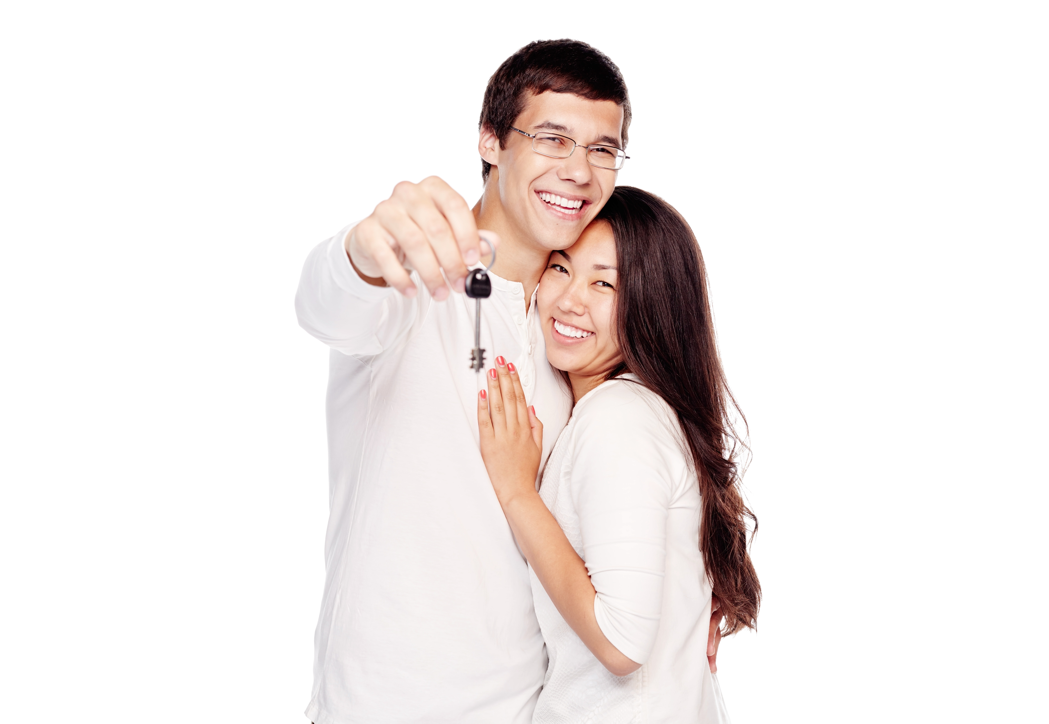 Lovely interracial couple, hispanic man and asian girl, showing key of their new house, hugging and smiling isolated on white background - real estate for young family concept