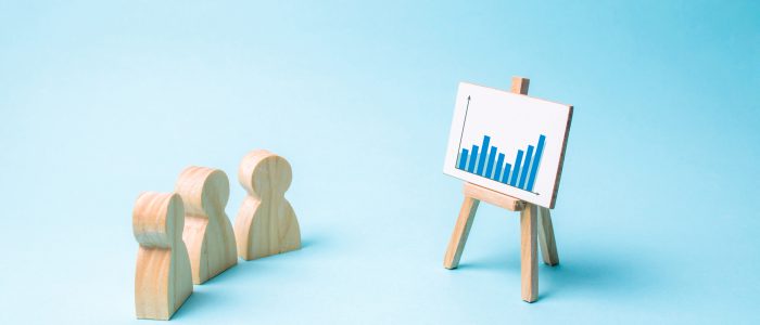 Three people look at the statistics and discuss business strategy and plans for the development of the company. Analysis of the results, familiarization with information, market analysis and marketing