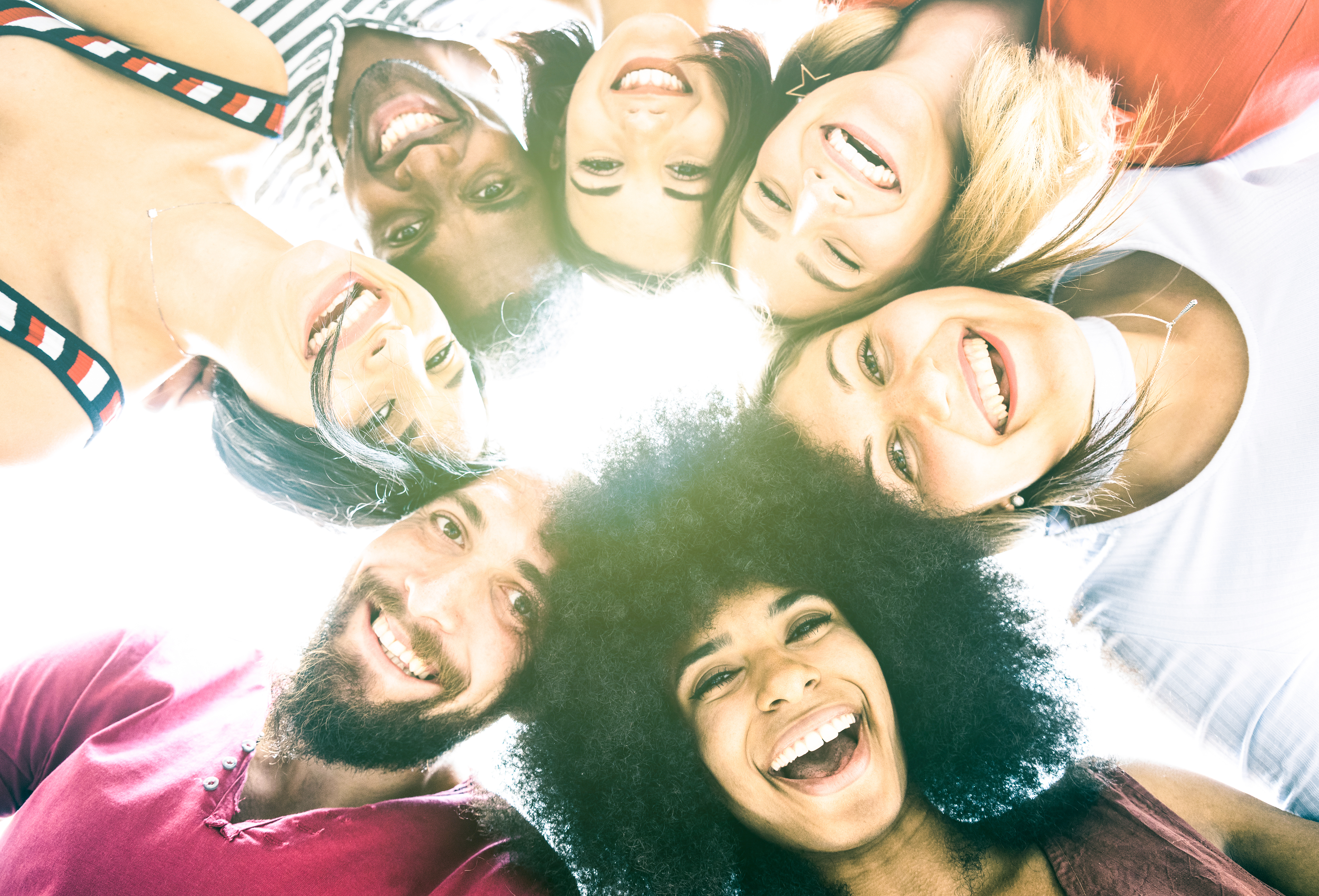 Multicultural best friends millenials taking selfie with back lighting - Happy youth friendship concept against racism with international young people having shared fun together - Vivid azure filter