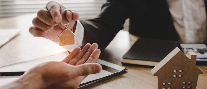 real estate broker manager giving house key to customer after signing contract for buying house in estate agent office, investment, home loan contract, buying house, real estate and insurance concept