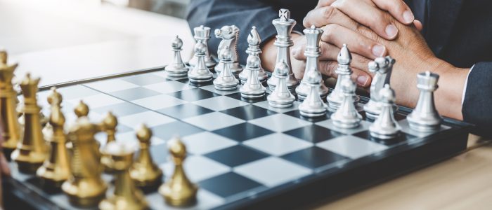 Two businessman playing chess game to plan strategy for success, thinking for planning overcoming difficulty and achieving goals business strategy for win.