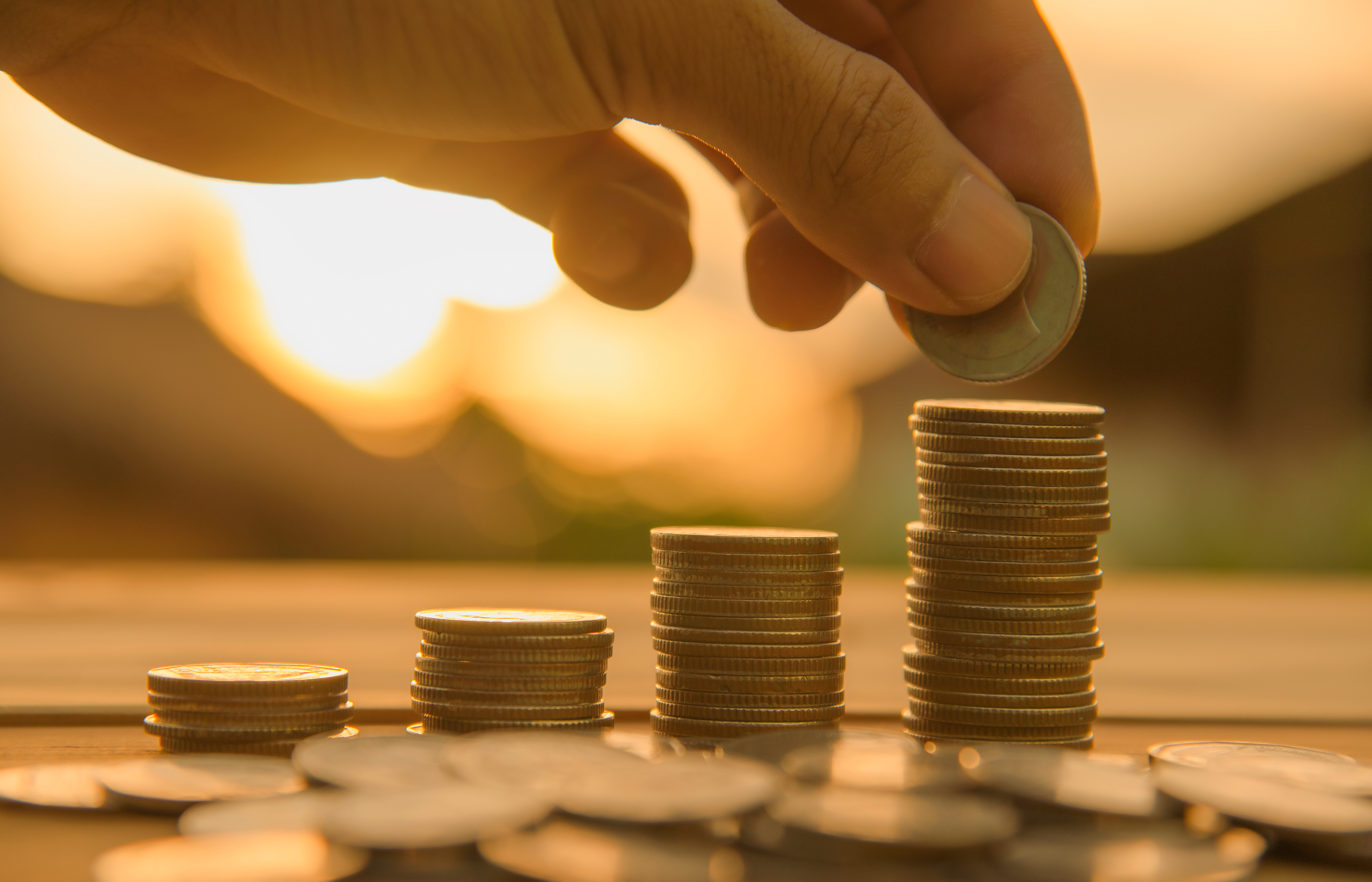 Saving money concept preset by Male hand putting money coin stack growing business. money finance coins money stacks savings money save cost saving