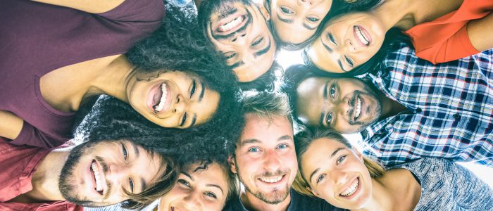 Multiracial best friends millennials taking selfie outdoors with back lighting - Happy youth friendship concept against racism with international young people having fun together - Azure filter tone